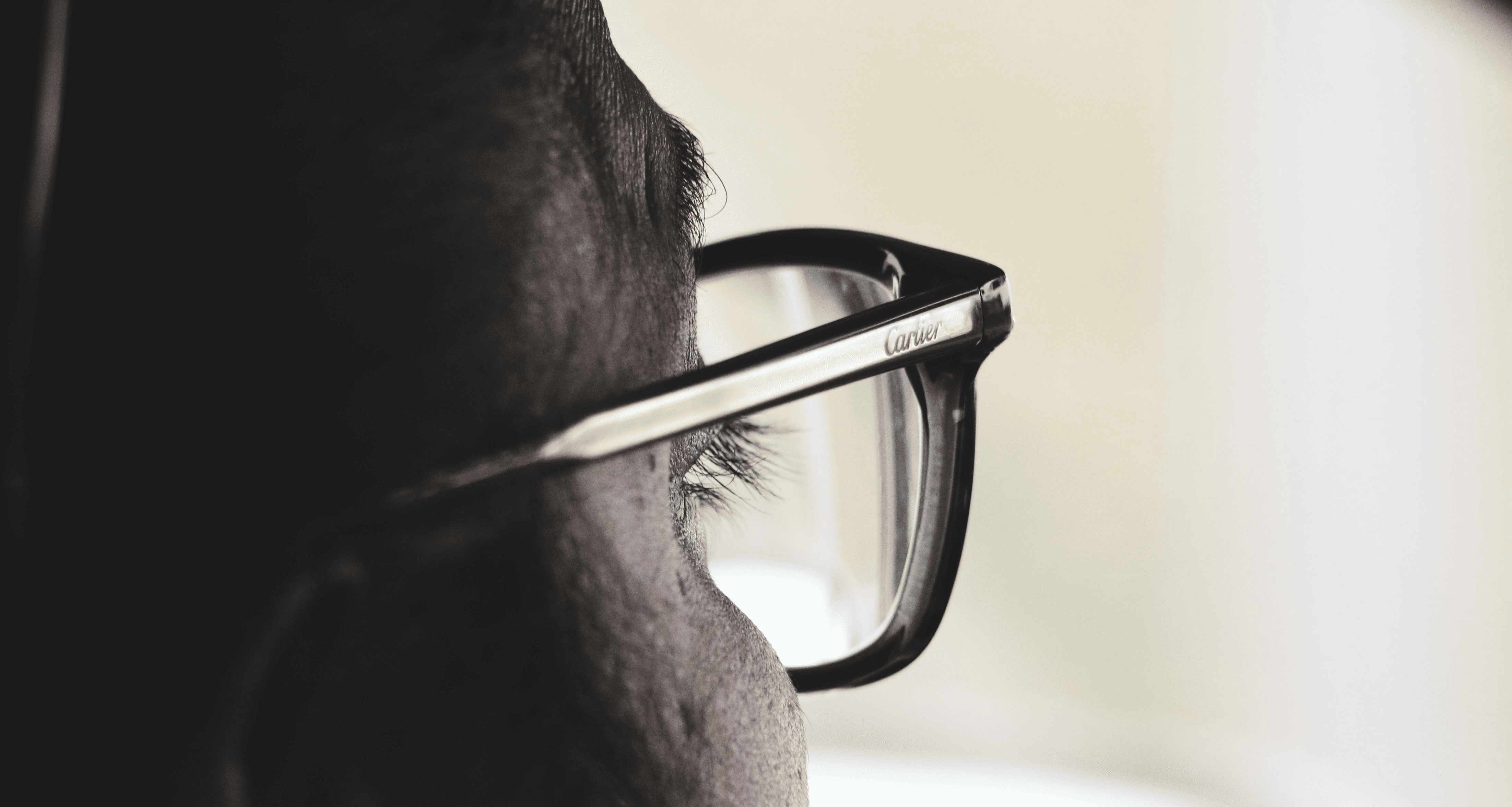 A close-up of a person wearing stylish designer eyeglass frames